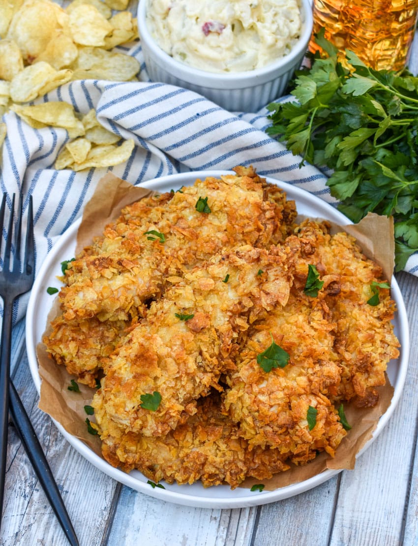 air fryer potato chip chicken tenders stacked on a white plate