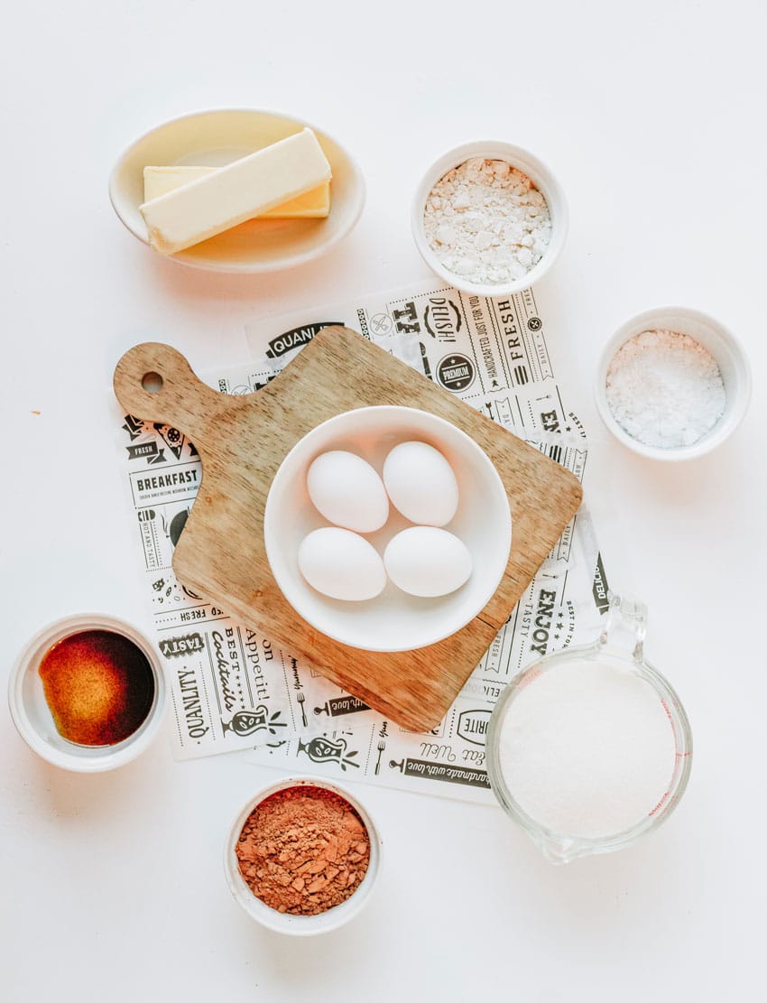 an overhead image showing the measured ingredients needed to make a batch of ina garten's famous baked brownie pudding
