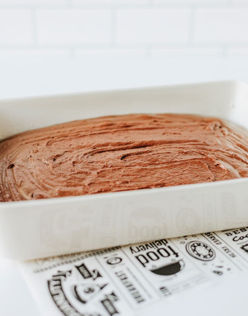 homemade brownie pudding batter in a white baking dish