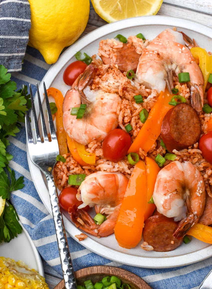 sheet pan jambalaya on a white plate with a silver fork resting on the side