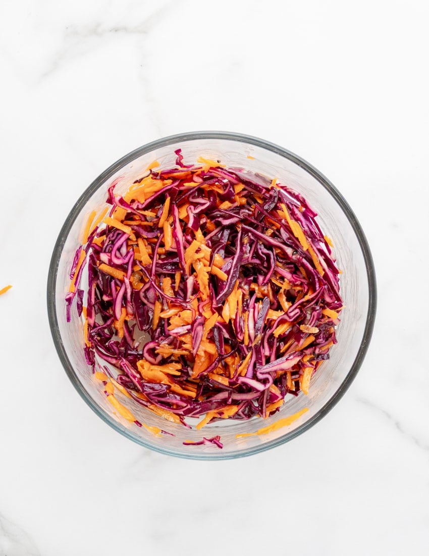 easy asian slaw in a glass mixing bowl