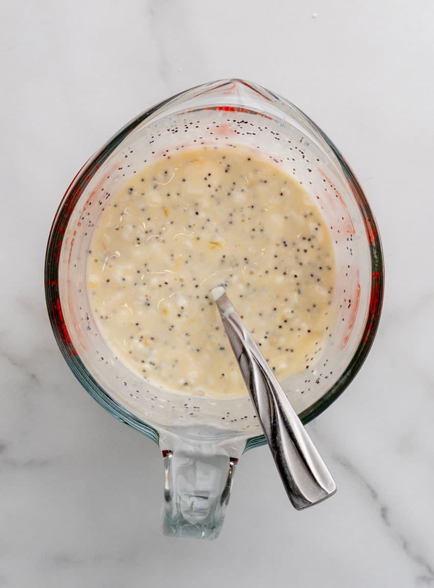 a homemade poppyseed salad dressing in a glass measuring cup