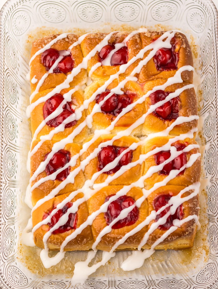 glazed cherry danish hawaiian rolls in a glass baking dish