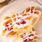 cherry danish hawaiian rolls stacked on a small white plate