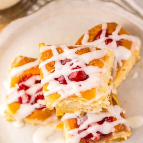 cherry danish hawaiian rolls stacked on a small white plate