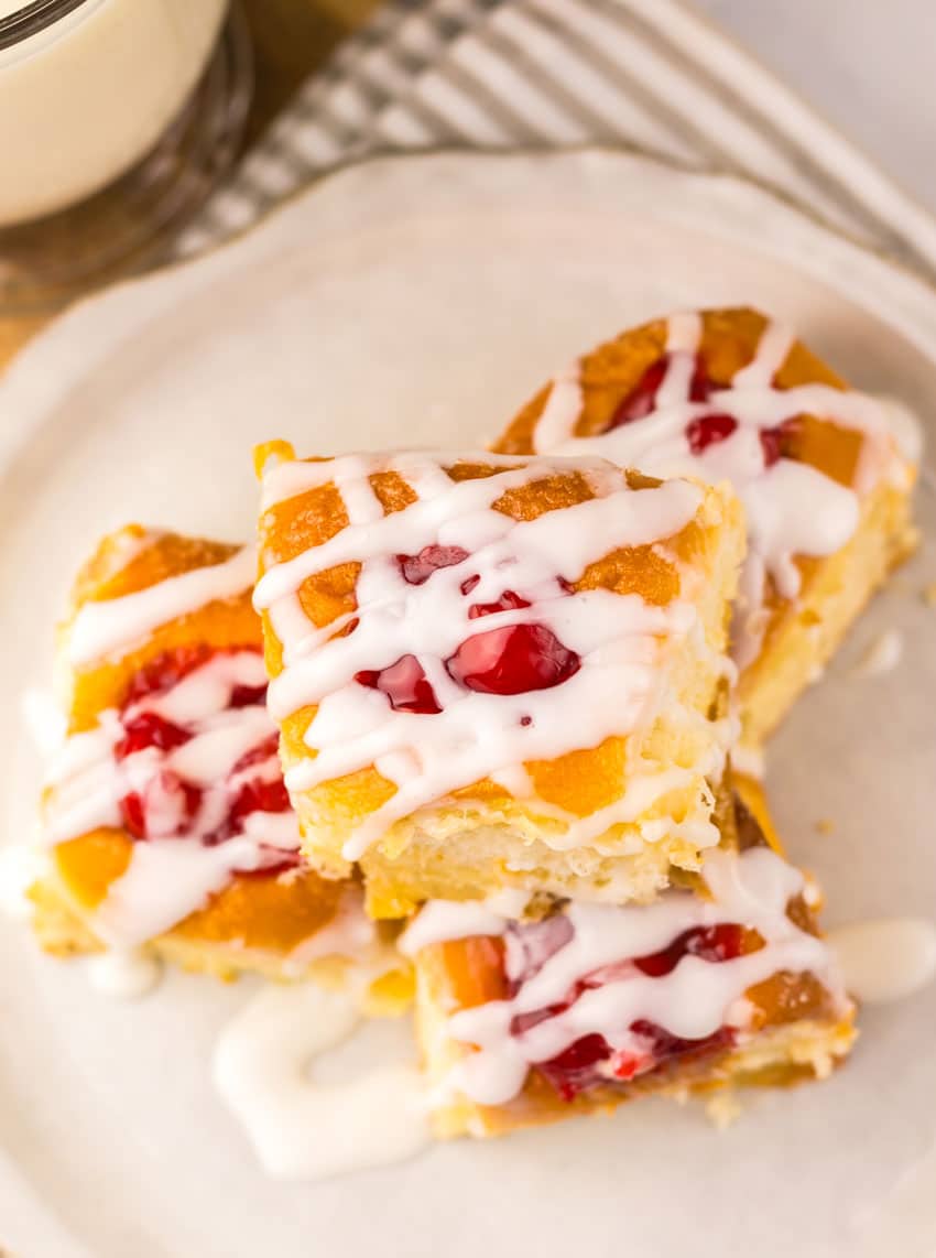cherry danish hawaiian rolls stacked on a small white plate