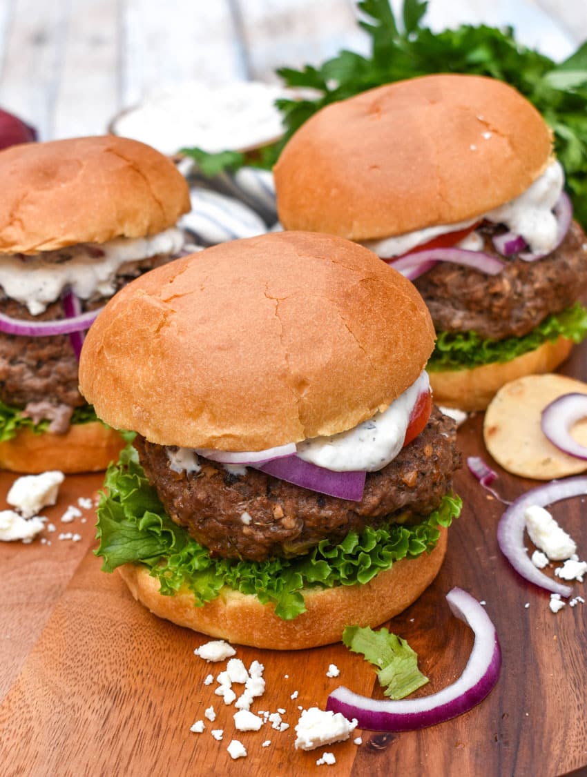 a homemade gyro burger on a wooden cutting board