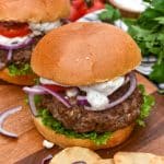 a homemade gyro burger on a wooden cutting board