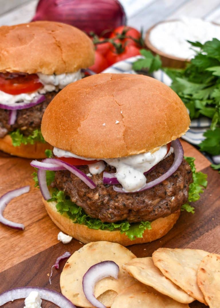 a homemade gyro burger on a wooden cutting board