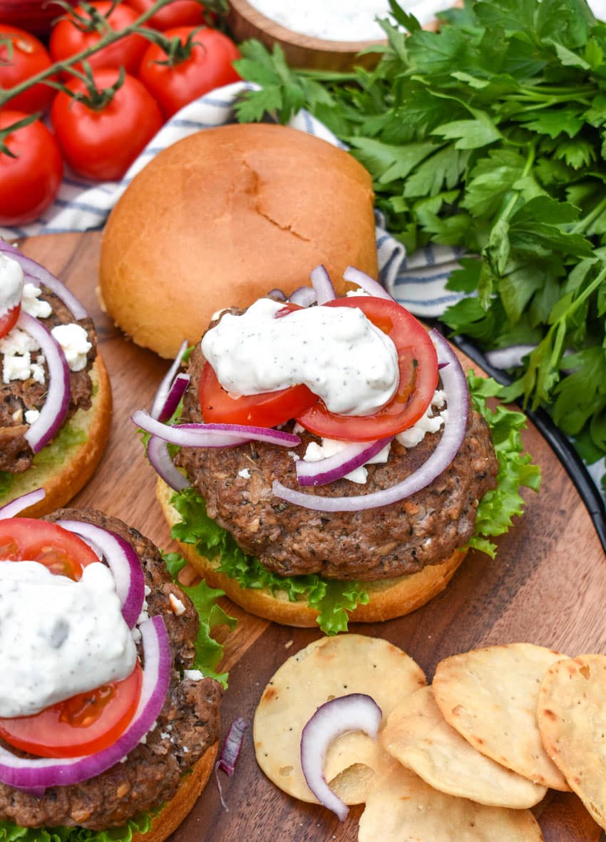 a homemade gyro burger on a wooden cutting board
