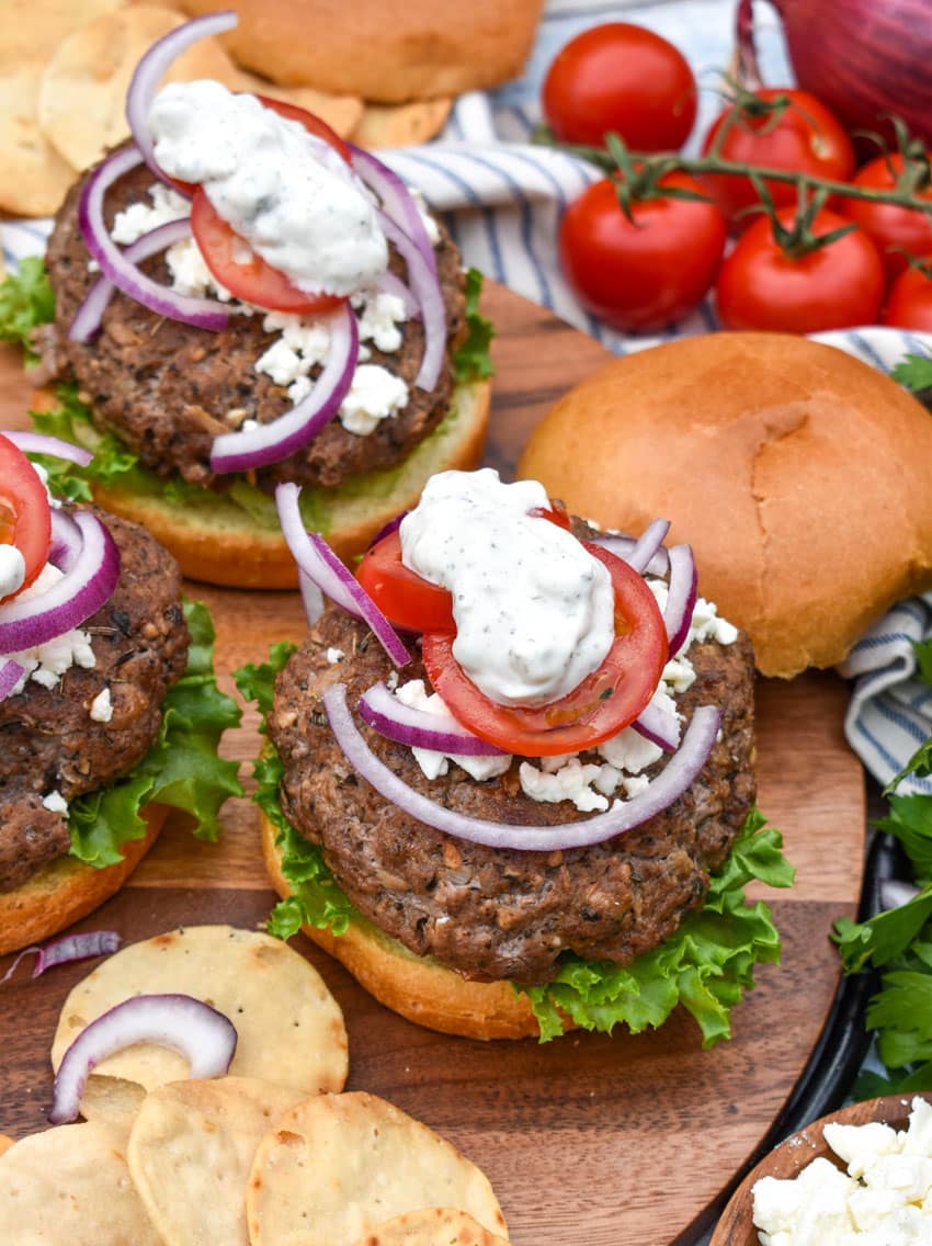 a homemade gyro burger on a wooden cutting board