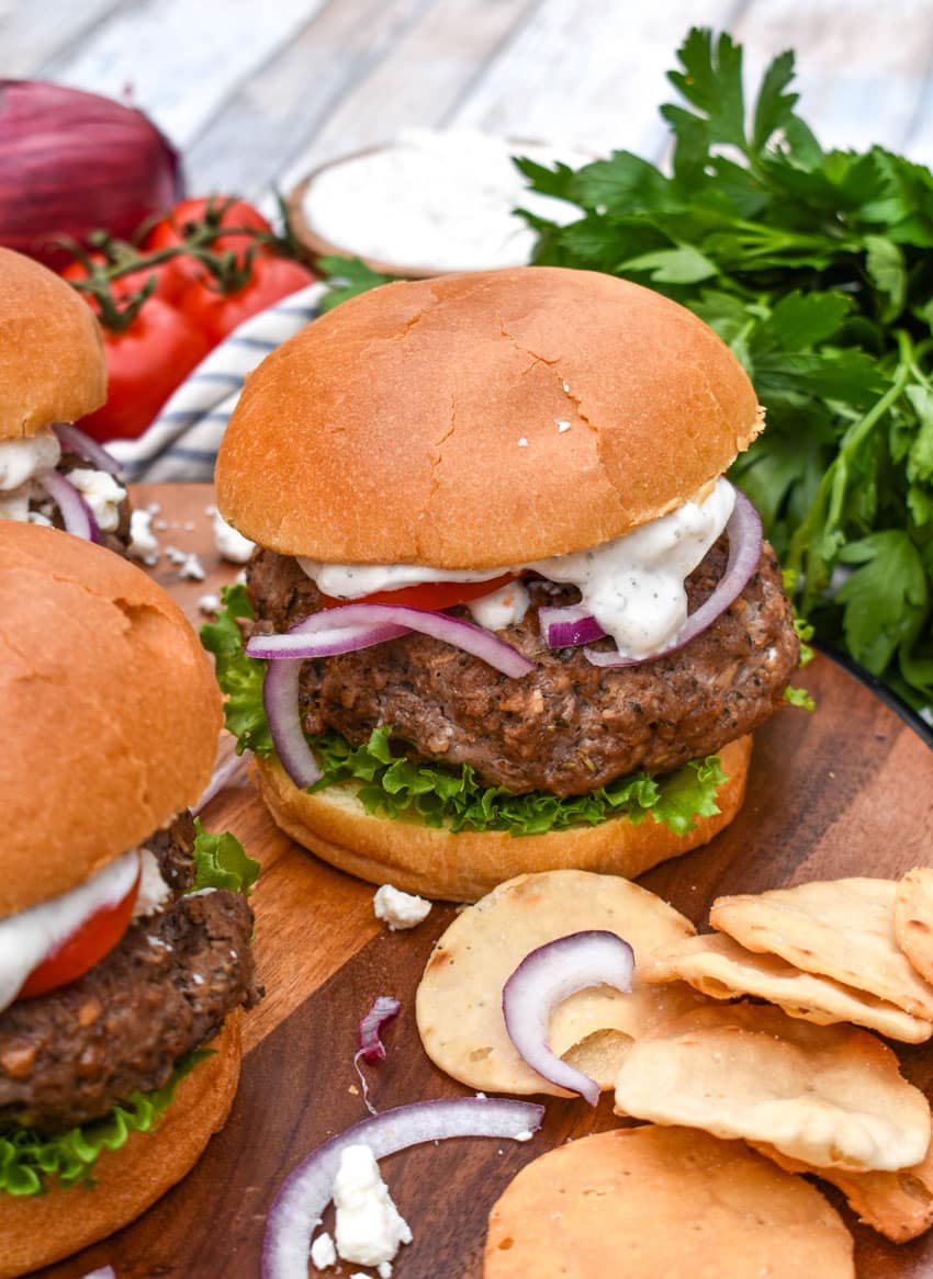a homemade gyro burger on a wooden cutting board
