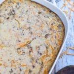 a mcgriddle breakfast casserole in a white baking dish with shredded cheese scattered around the sides
