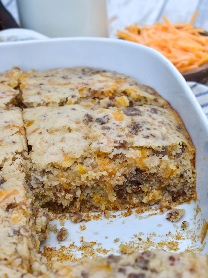 a homemade mcgriddle breakfast pancake casserole in a white baking dish with a slice removed to show the inside layer