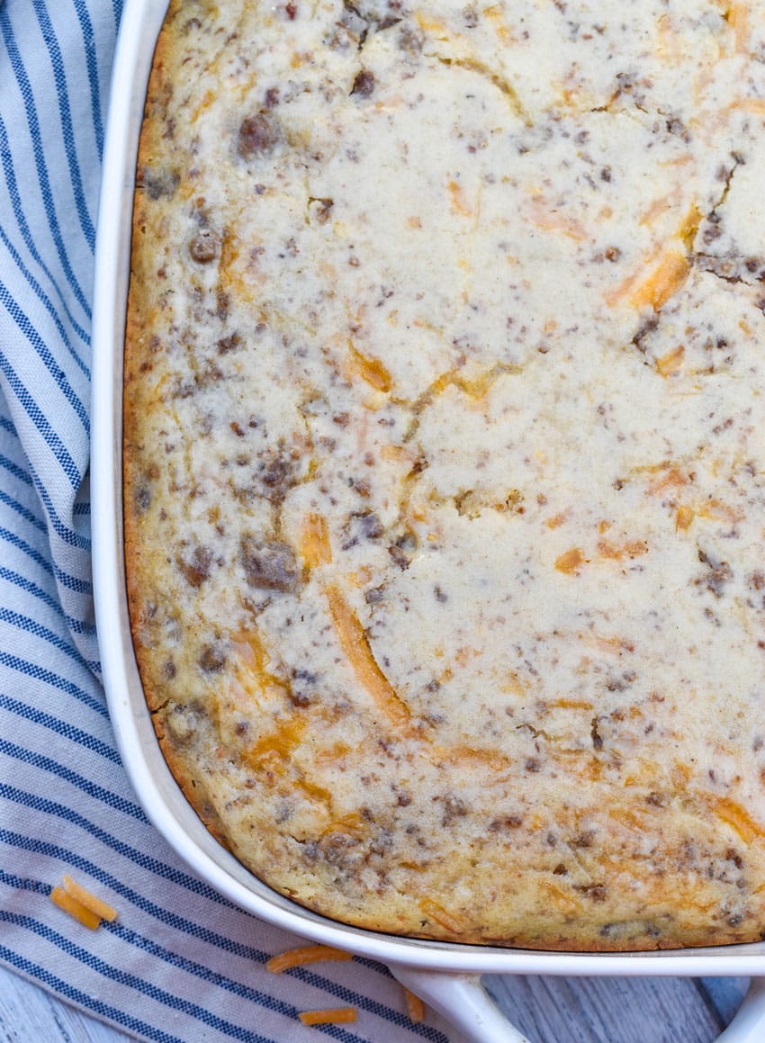 a mcgriddle breakfast casserole in a white baking dish with shredded cheese scattered around the sides