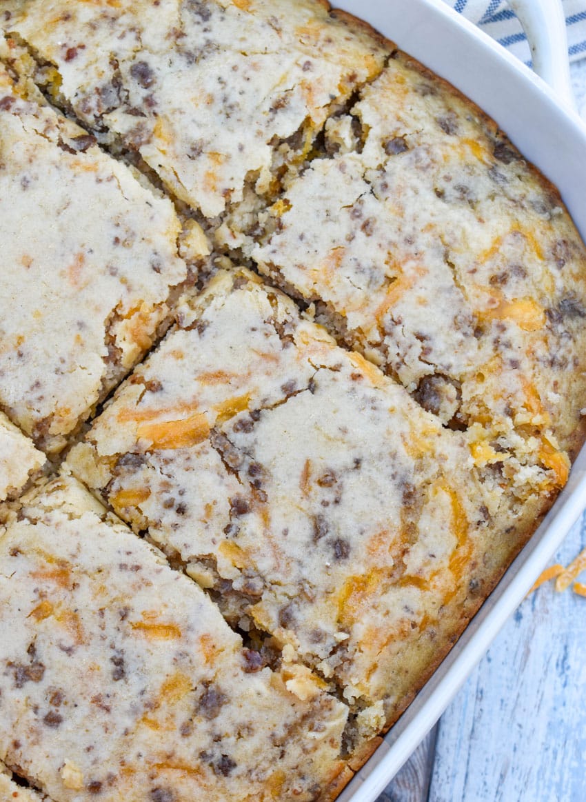 a mcgriddle breakfast casserole in a white baking dish with shredded cheese scattered around the sides