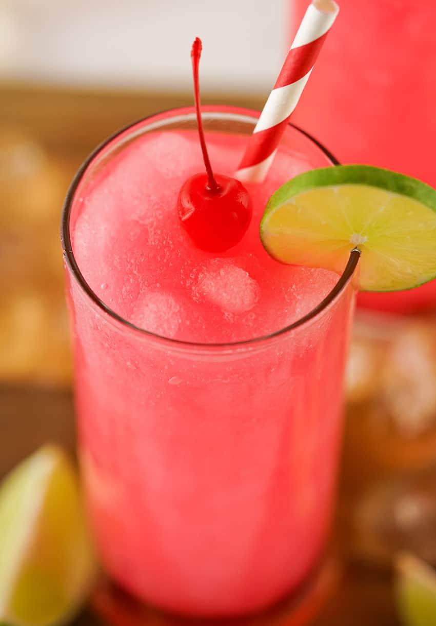 frozen dirty shirley's in two small glasses on a wooden cutting board