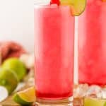 frozen dirty shirley's in two small glasses on a wooden cutting board
