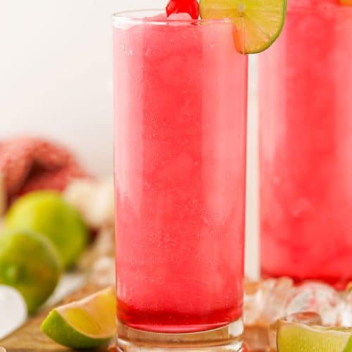 frozen dirty shirley's in two small glasses on a wooden cutting board