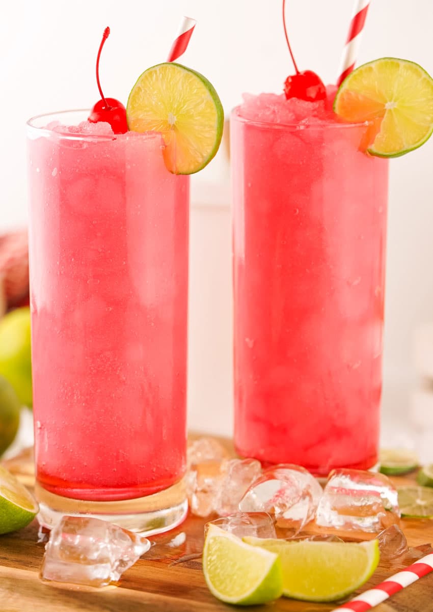 frozen dirty shirley's in two small glasses on a wooden cutting board