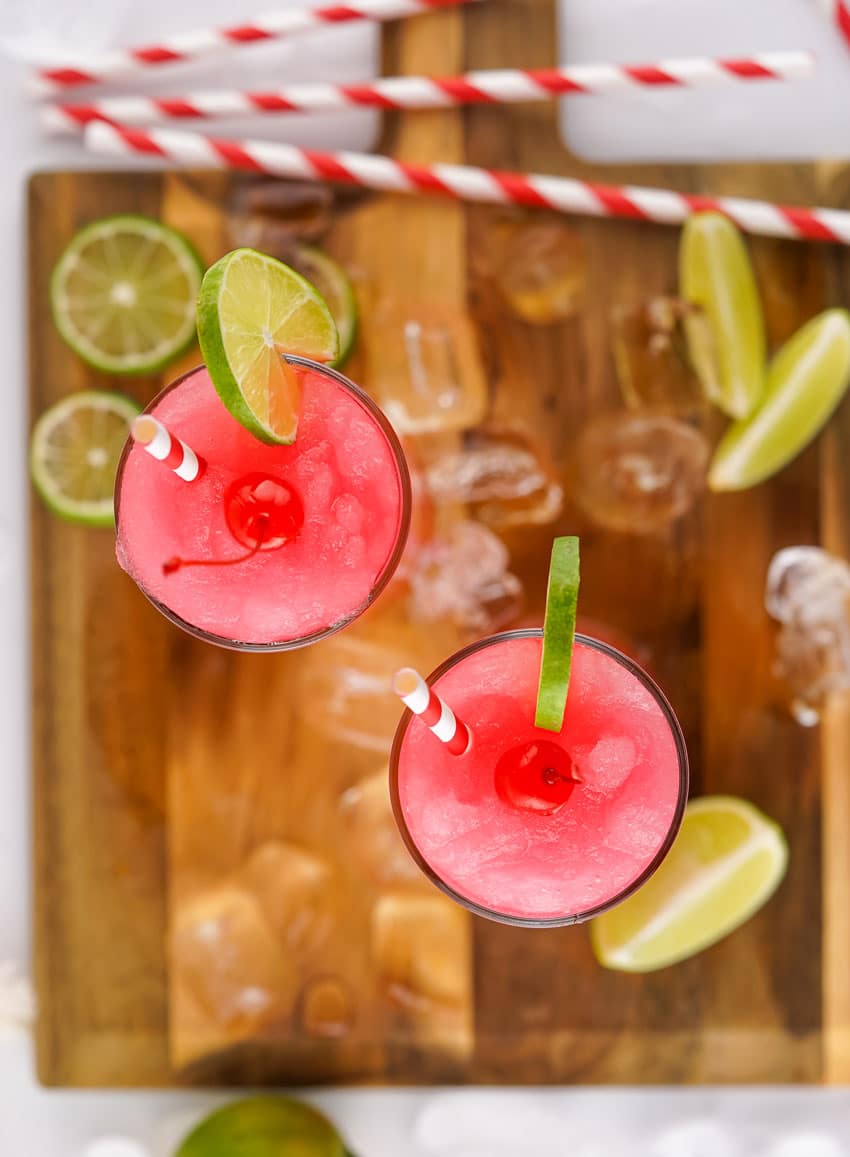 frozen dirty shirley's in two small glasses on a wooden cutting board