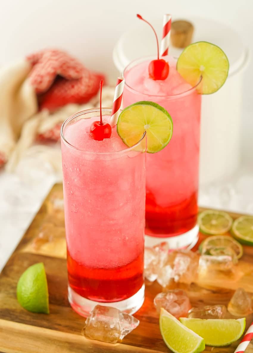 frozen dirty shirley's in two small glasses on a wooden cutting board