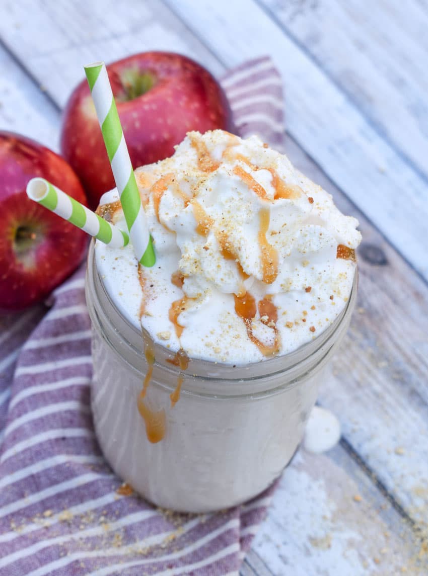 a caramel topped apple pie milkshake in a small glass jar