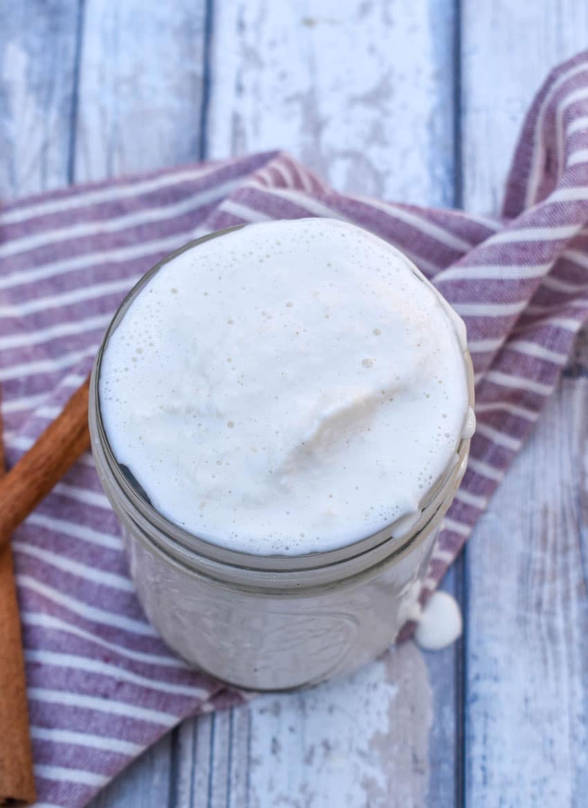 a homemade apple pie milkshake in a small glass jar