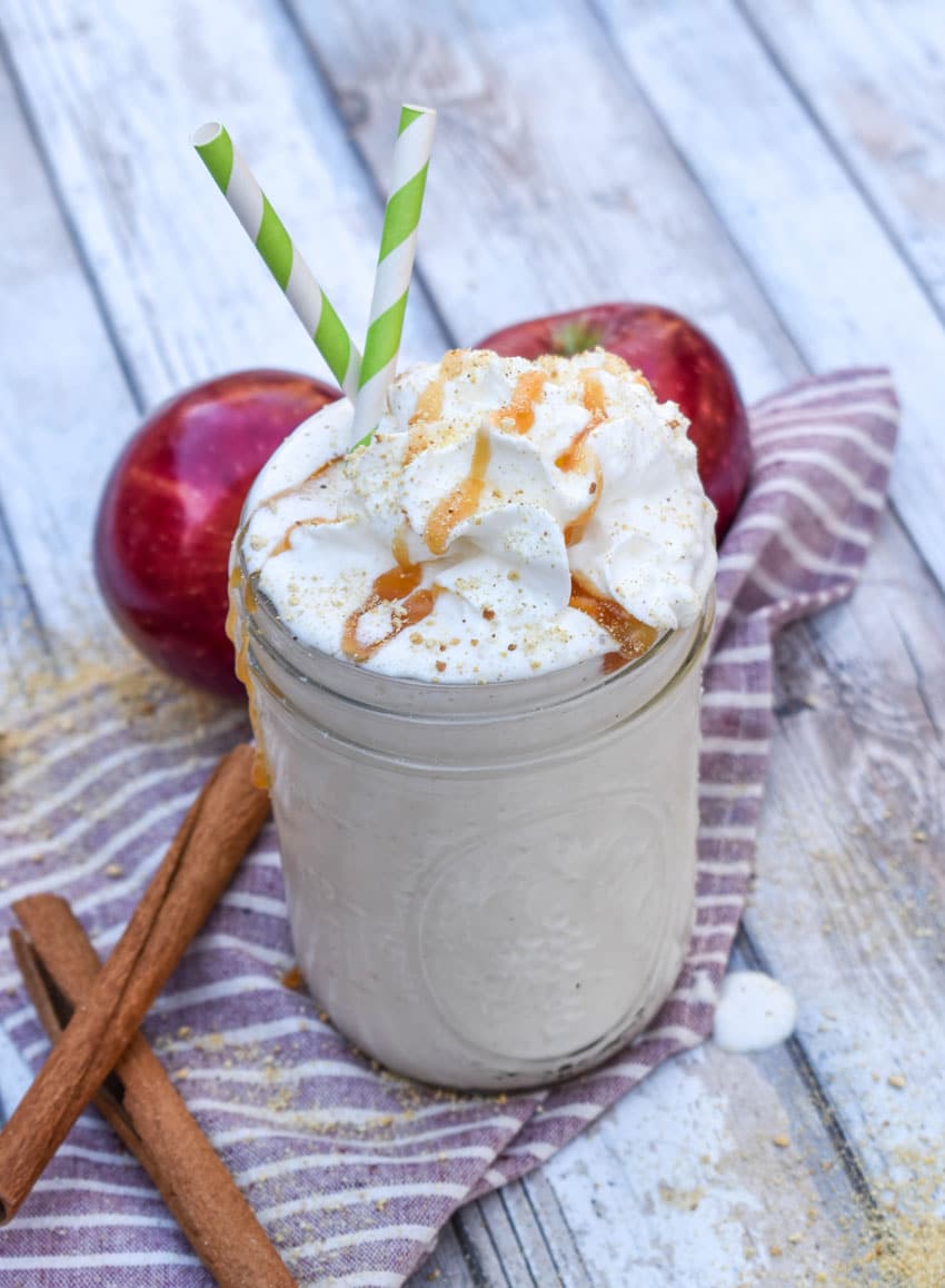 a caramel topped apple pie milkshake in a small glass jar