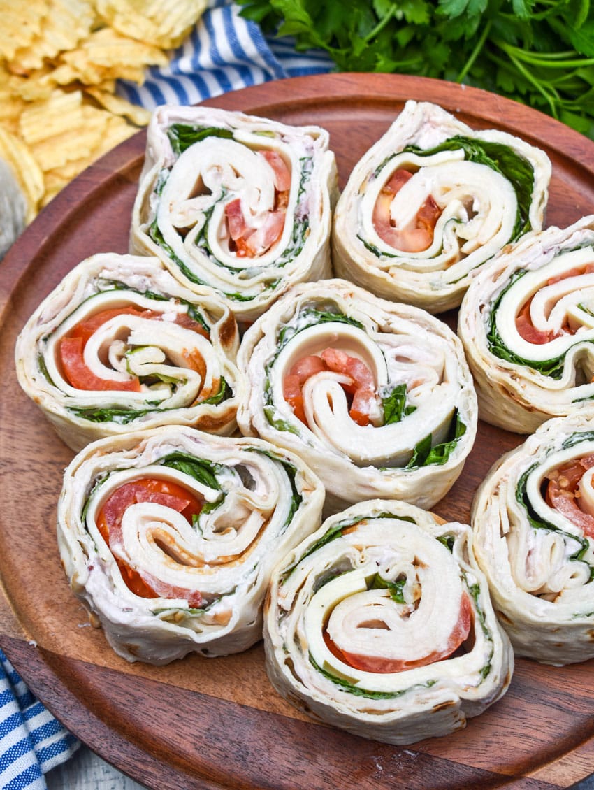 copycat costco turkey swiss pinwheels stacked on a wooden cake stand