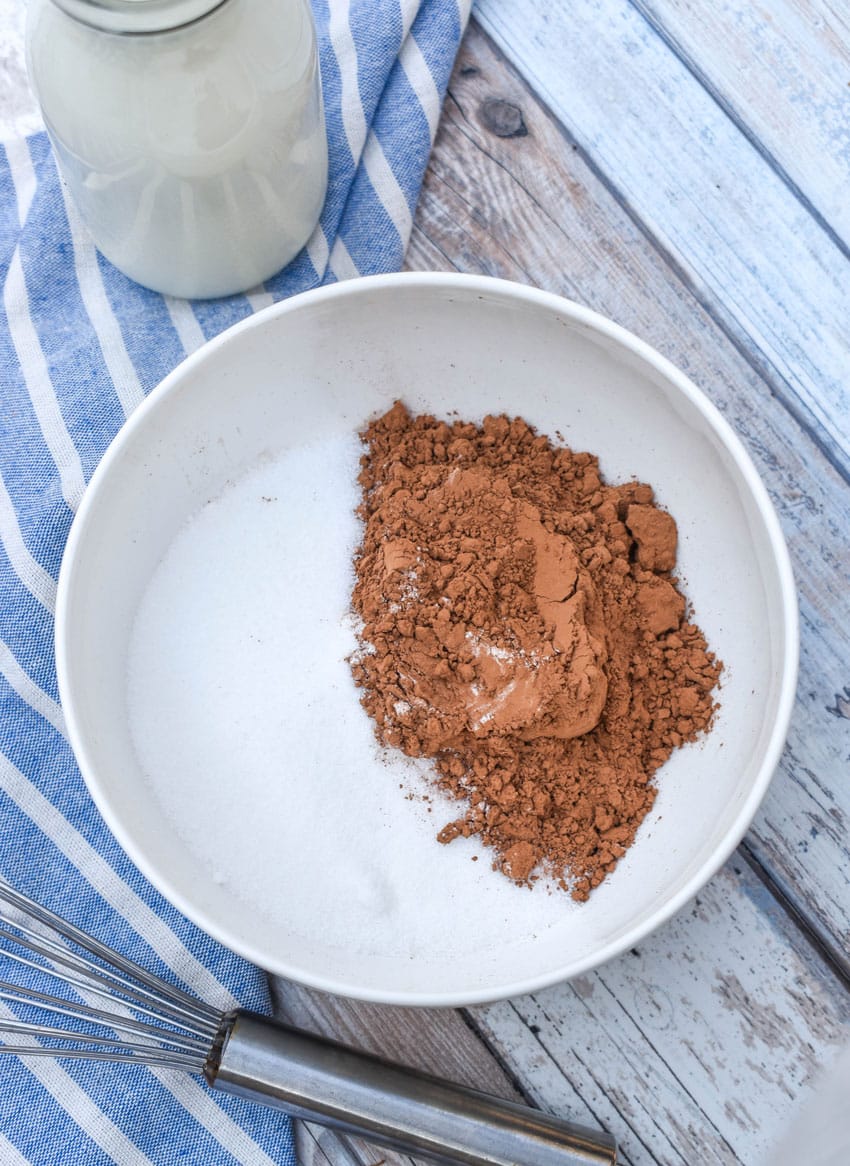 unsweetened cocoa powder and granulated sugar in a white bowl
