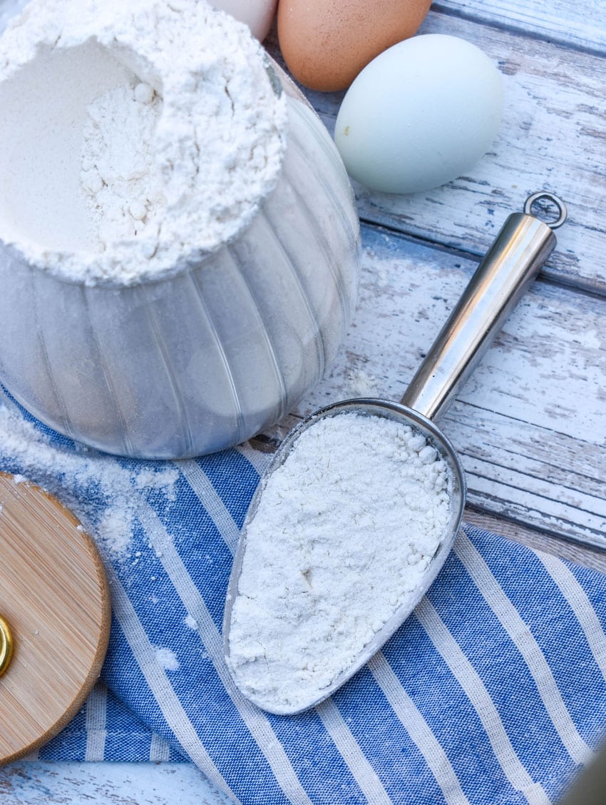 a metal scoop filled with homemade pancake mix resting on a wooden table