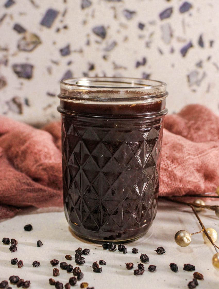 homemade elderberry syrup in a small glass jar