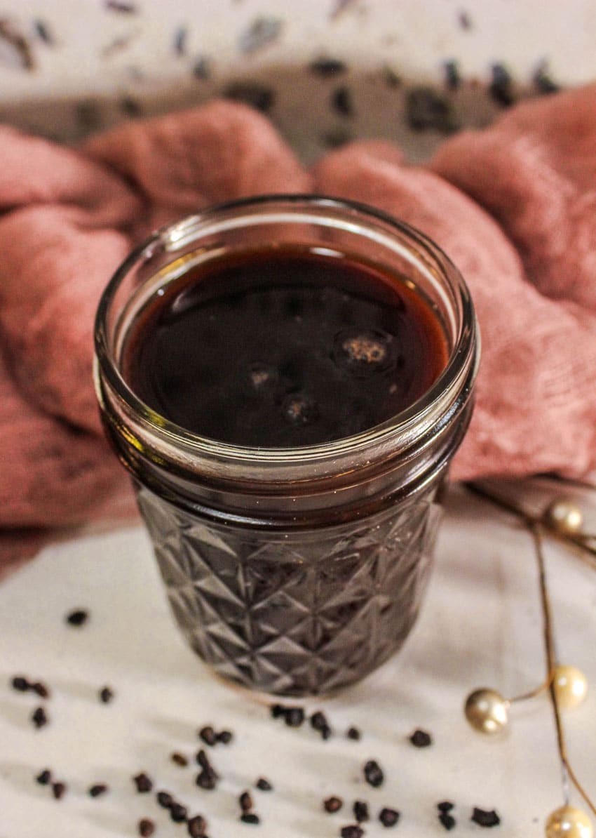 homemade elderberry syrup in a small glass jar