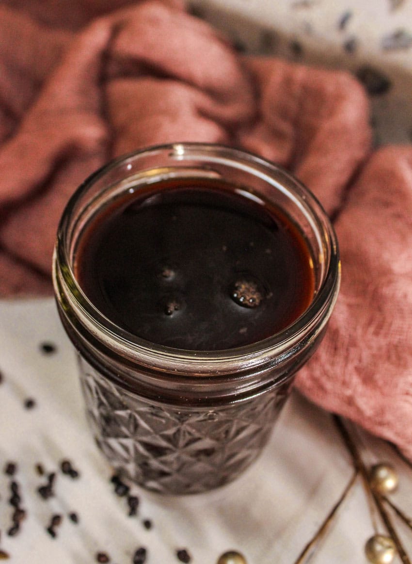 homemade elderberry syrup in a small glass jar