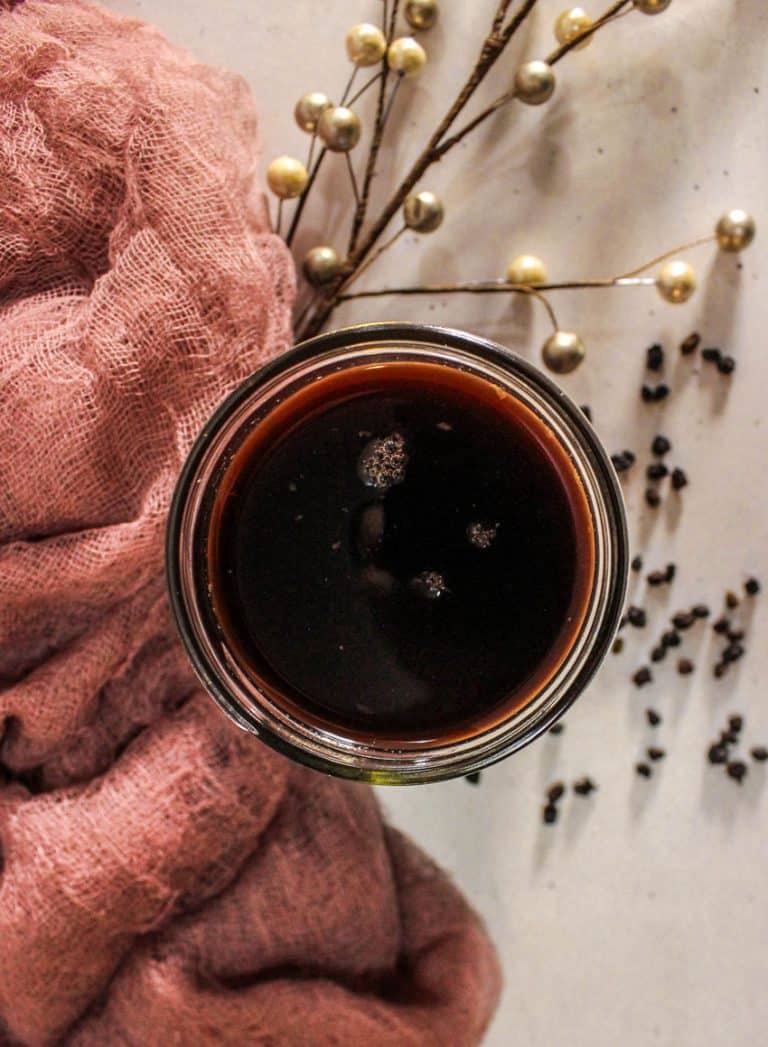 homemade elderberry syrup in a small glass jar