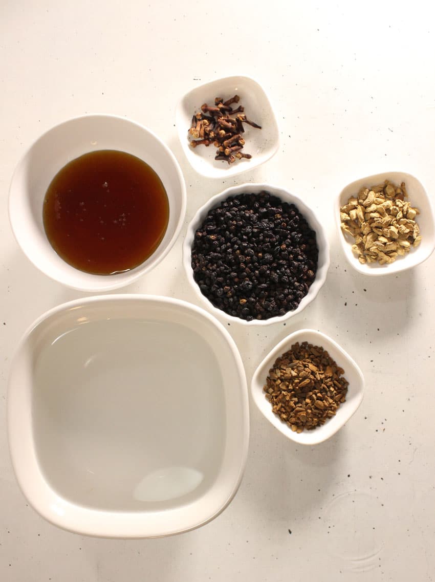 an overhead image showing the measured ingredients needed to make a batch of homemade elderberry syrup