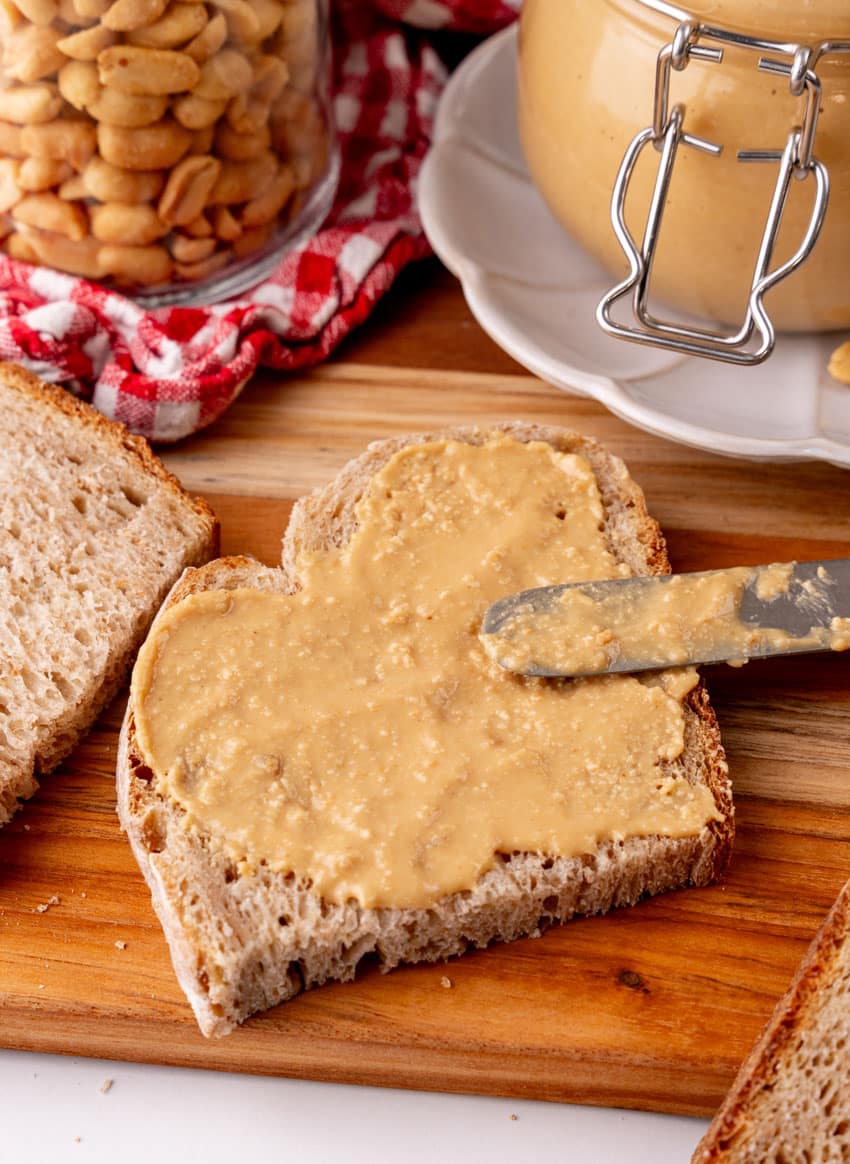 homemade peanut butter spread on soft wheat sandwich bread