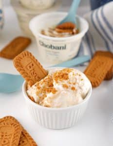 viral japanese biscoff greek yogurt cheesecake topped with cookie crumbs in a small white ramekin