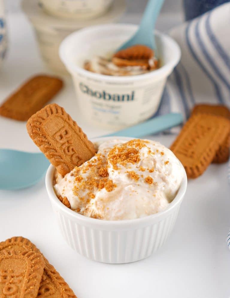viral japanese biscoff greek yogurt cheesecake topped with cookie crumbs in a small white ramekin