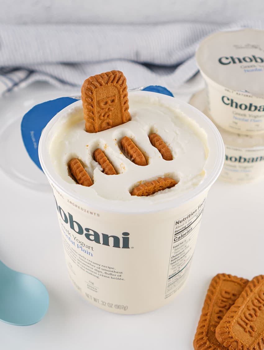 biscoff cookies sitting in a tub of plain greek yogurt