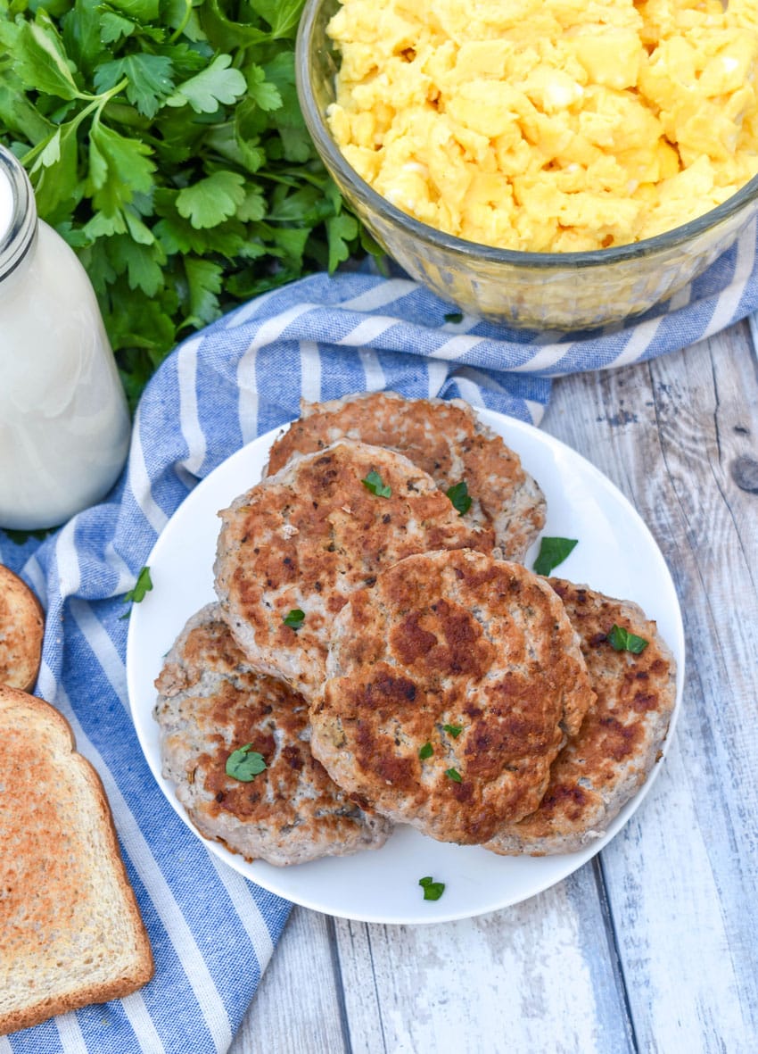 homemade breakfast sausage patties stacked on a small white plate
