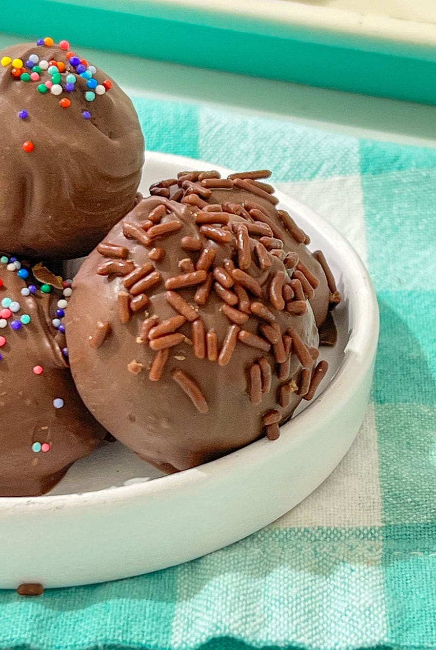 homemade brownie cheesecake truffles in a small white bowl