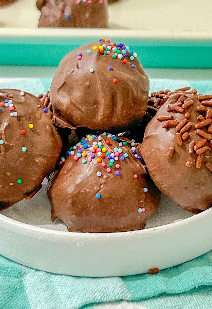 homemade brownie cheesecake truffles in a small white bowl