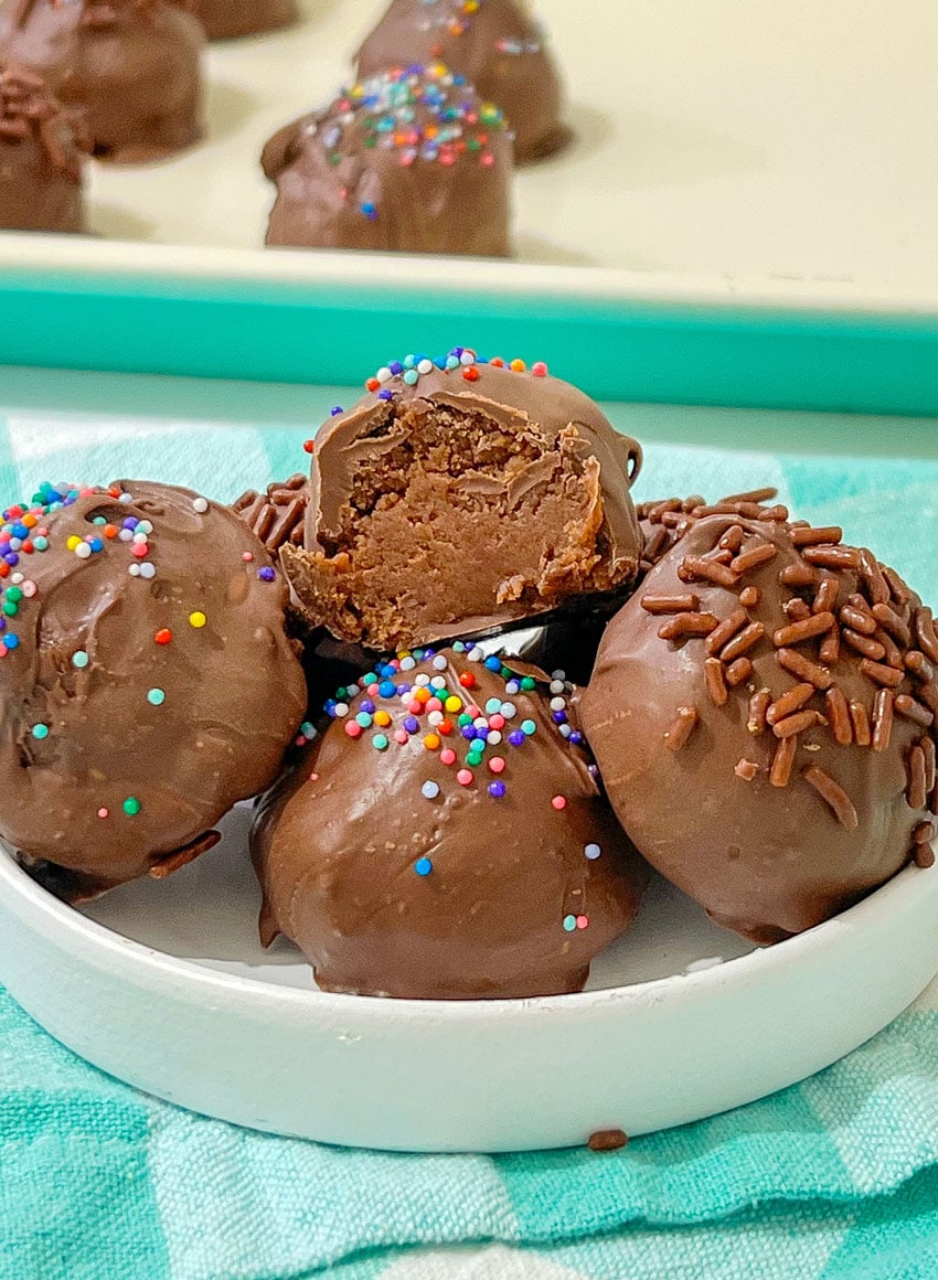 homemade brownie cheesecake truffles in a small white bowl
