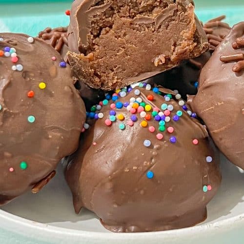 homemade brownie cheesecake truffles in a small white bowl