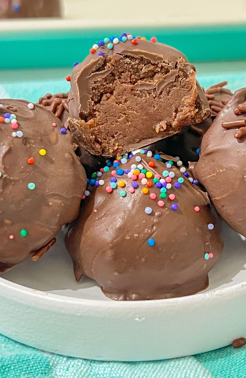 homemade brownie cheesecake truffles in a small white bowl