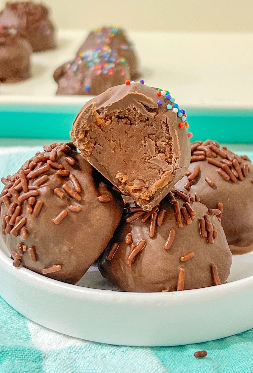 homemade brownie cheesecake truffles in a small white bowl