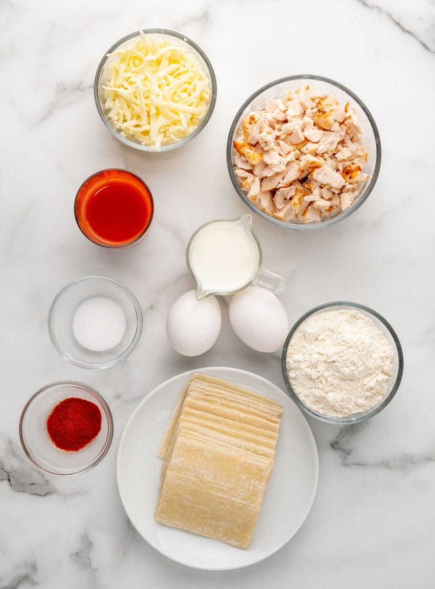 an overhead image showing the measured ingredients needed to make a batch of copycat cheesecake factory buffalo blasts