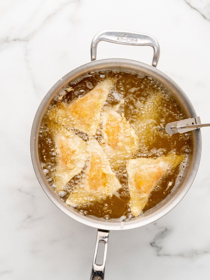 homemade cheesecake factory buffalo blasts frying in a pot of hot oil